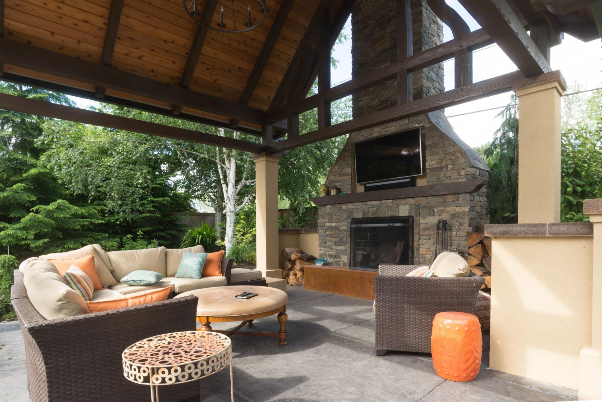 outdoor covered patio with fireplace and TV